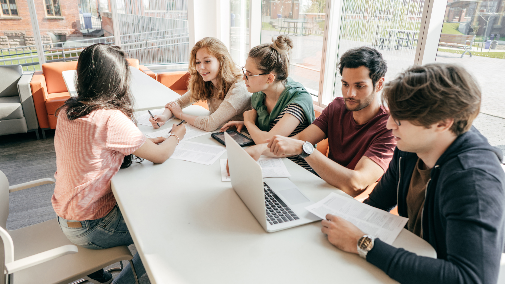 International students sitting at a desk browsing study abroad resources 